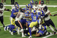 Los Angeles Rams players try to push running back Malcolm Brown into the end zone during the second half of an NFL football game against the Chicago Bears Monday, Oct. 26, 2020, in Inglewood, Calif. (AP Photo/Ashley Landis )