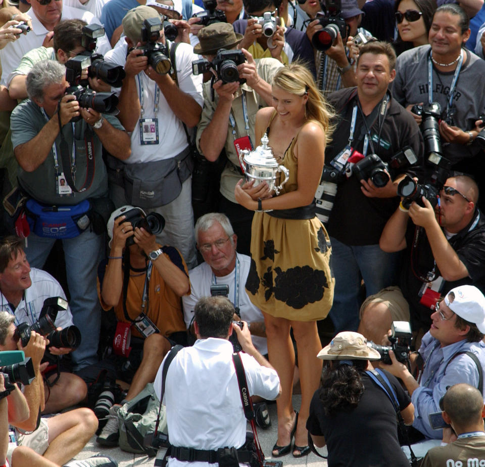 FILE - In this Sept. 10, 2006, file photo, Maria Sharapova, the U.S. Open tennis women's singles champion, poses with her trophy in New York. Sharapova is retiring from professional tennis at the age of 32 after five Grand Slam titles and time ranked No. 1. She has been dealing with shoulder problems for years. In an essay written for Vanity Fair and Vogue about her decision to walk away from the sport, posted online Wednesday, Feb. 26, 2020, Sharapova asks: “How do you leave behind the only life you’ve ever known?” (AP Photo/Osamu Honda, File)