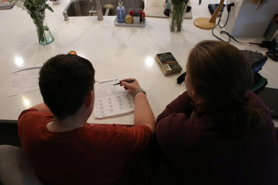 Joey (left) works on math homework with his mother's help in this file photo from Makenzie Huber of South Dakota Searchlight.