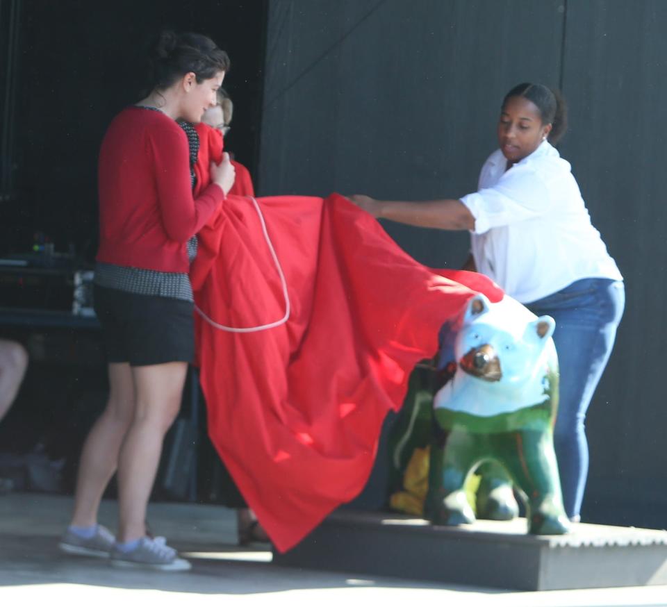 Diamond Cash, far right, helps unveil her bear, Celebration '22 to benefit Friends of Downtown Hendersonville at Thursday's Bearfootin' Bears reveal.