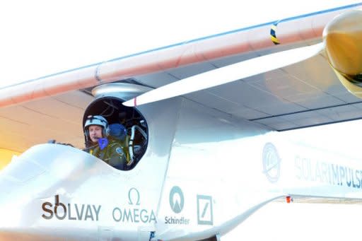 Swiss pilot Bertrand Piccard sits in the cockpit of the Swiss-made Solar-powered aircraft the Solar Impulse as he prepares for take-off from Rabat on June 21, for a voyage across the Moroccan desert, to Ouarzazate. Solar Impulse early Friday completed a flight over the desert to showcase renewable energy, as a key summit in Rio discussed "greening" the world economy