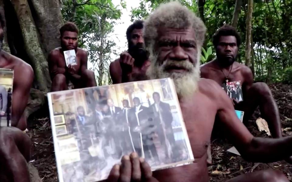 Chief Yapa from the village of Ikunala offered condolences to the British royal family, holding a photo of himself and other local men who went to the UK in 2007 to meet Prince Philip - Reuters