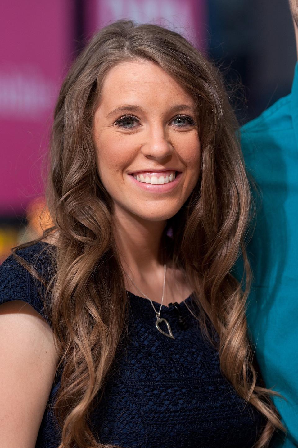 Jill Duggar has a passionate and attractive smile on her face as she poses for the camera