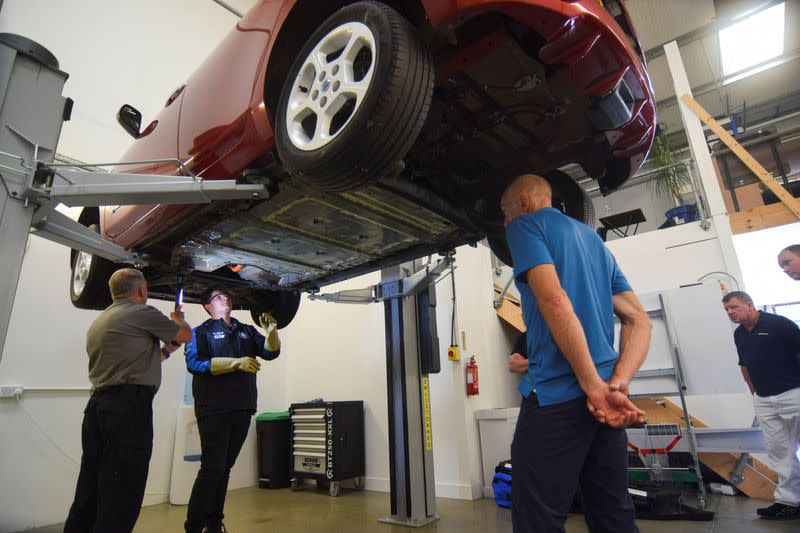 An instructor at automotive training provider Pro-Moto during an electric vehicle repair course in Ash Vale