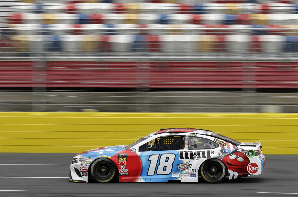 Kyle Busch (18) drives his car during practice for the NASCAR Cup series auto race at Charlotte Motor Speedway in Charlotte, N.C., Thursday, May 24, 2018. (AP Photo/Chuck Burton)