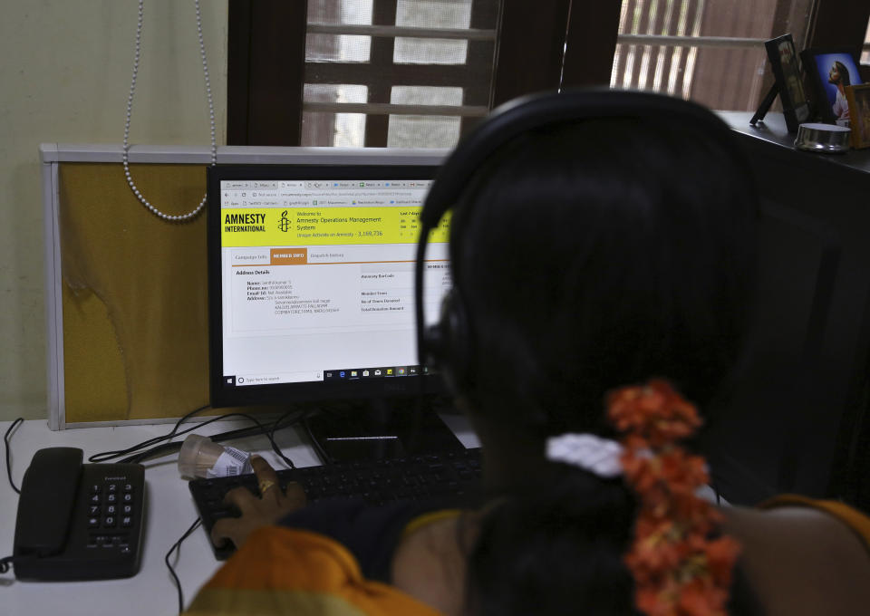 An Amnesty International India employee interacts at the call center of their headquarters in Bangalore, India, Tuesday, Feb. 5, 2019. International rights groups and foreign aid organizations with deep roots in India say they are struggling to operate under the administration of Prime Minister Narendra Modi, whose Hindu nationalist Bharatiya Janata Party has elevated the role of homegrown social groups while cracking down on foreign charities. (AP Photo/Aijaz Rahi)