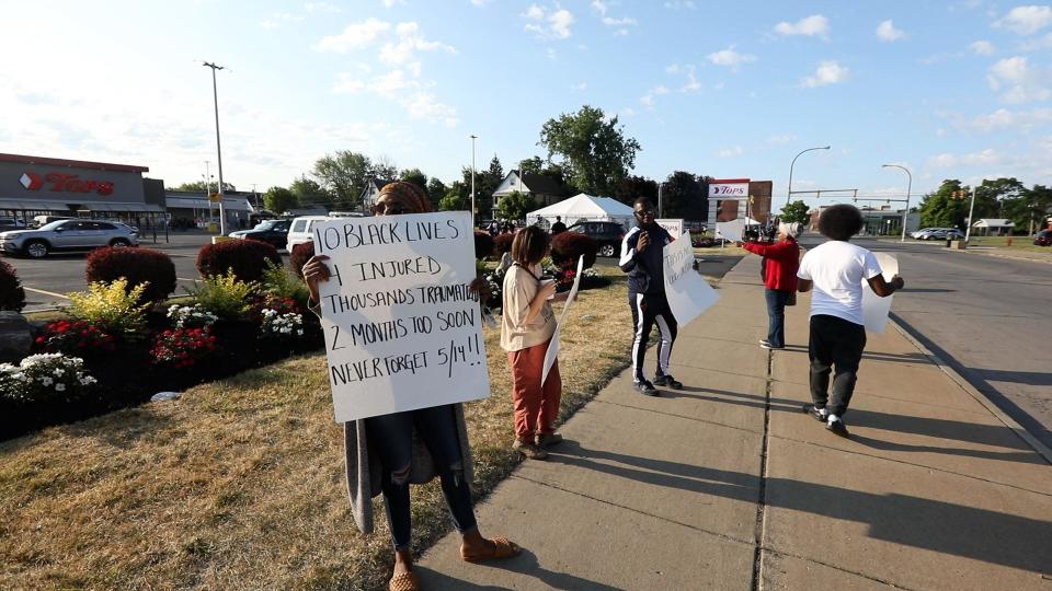  A small group of people protest the opening of the Tops Friendly Market on Jefferson Ave., Buffalo, NY on July 15, 2022.  The group said the site should be a memorial and it is too early to open the store, two months after 10 people were killed and three others injured at a shooting at the store where a man came from out of town to attack Black people.