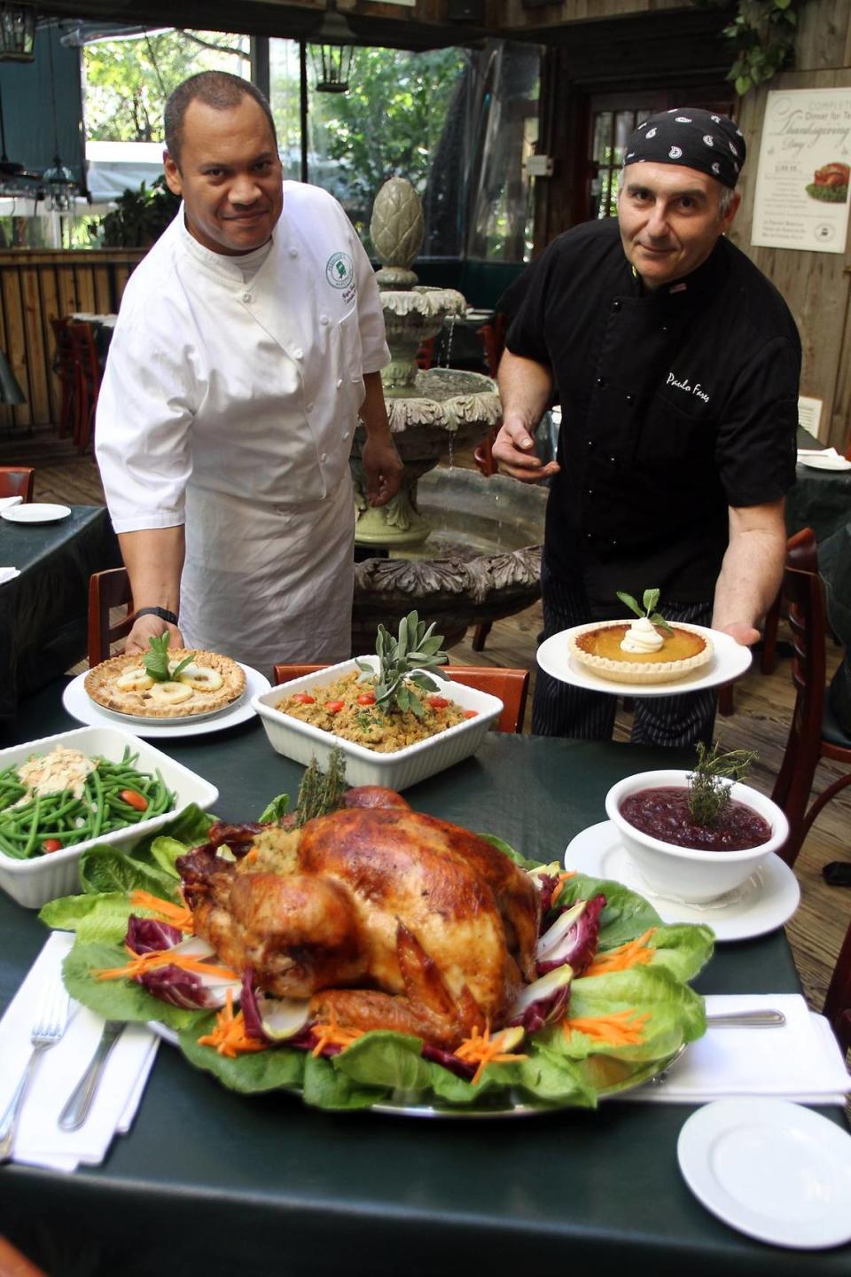 From left, executive chef Roger Berrios and sous chef Paulo Fares at Perricone’s Marketplace display the restaurant’s Thanksgiving meal to-go offerings in 2010.