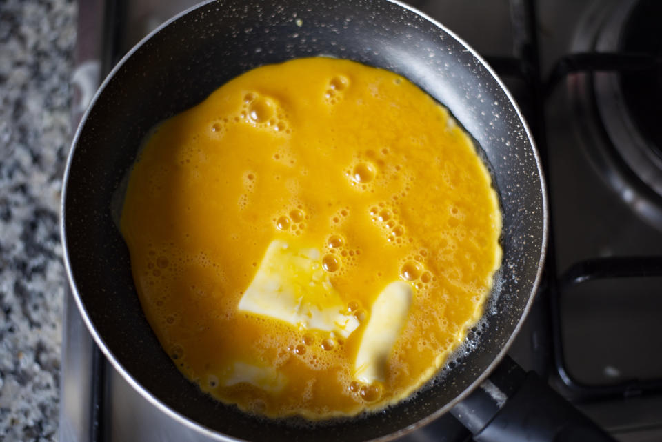 Eggs cooking in a skillet.