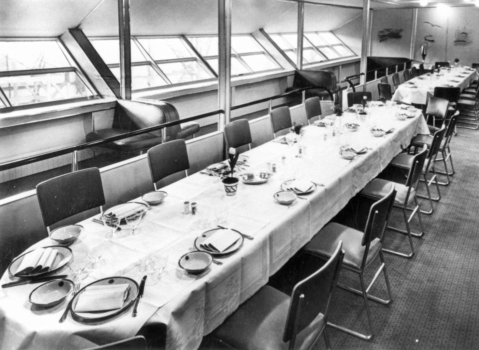 The Hindenburg's dining hall showing two long tables with simple chairs and place settingsg