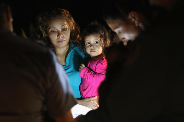 <p>Central American asylum seekers, including a Honduran girl, 2, and her mother, are taken into custody near the U.S.-Mexico border on June 12, 2018 in McAllen, Texas. (Photo: John Moore/Getty Images) </p>