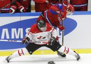 Russia's Bogdan Yakimov (R) battles for the puck with Canada's Aaron Ekblad during the third period of their IIHF World Junior Championship bronze medal ice hockey game in Malmo, Sweden, January 5, 2014. REUTERS/Alexander Demianchuk (SWEDEN - Tags: SPORT ICE HOCKEY)