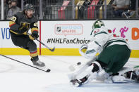 Vegas Golden Knights center Chandler Stephenson (20) shoots against Minnesota Wild goaltender Cam Talbot (33) during the second period of an NHL hockey game Monday, May 24, 2021, in Las Vegas. (AP Photo/John Locher)