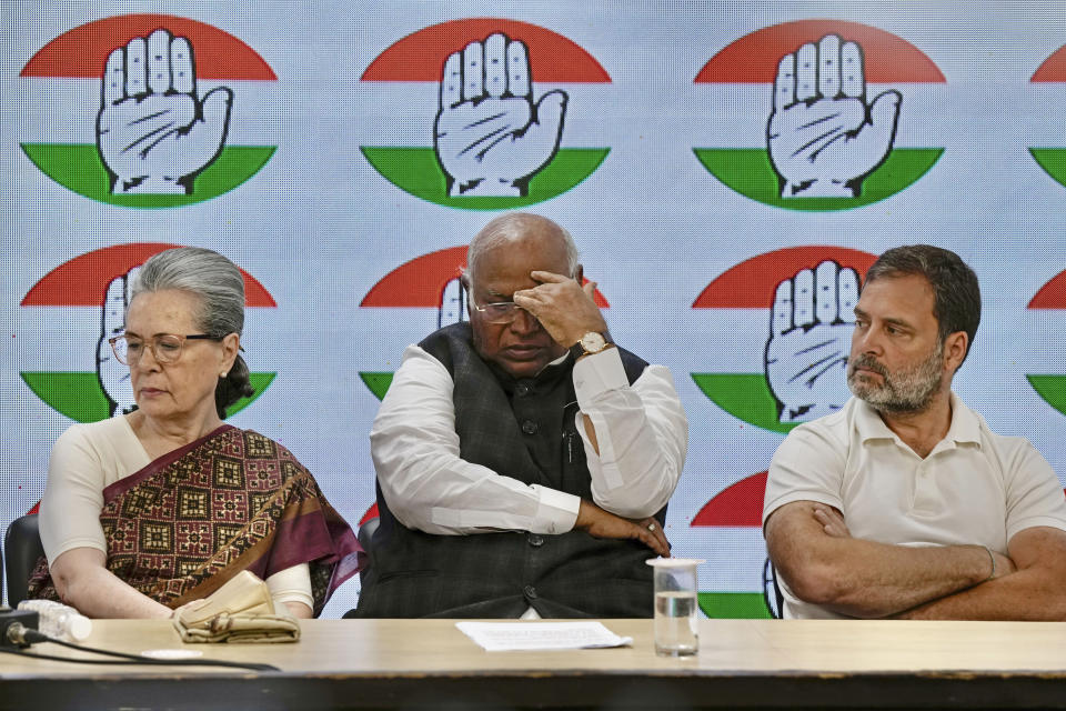Congress party president Mallikarjun Kharge, center, flanked by senior party leaders Sonia Gandhi, left, and Rahul Gandhi attend a press conference at their party headquarters in New Delhi, India, Thursday, March 21, 2024. (AP Photo/Manish Swarup)