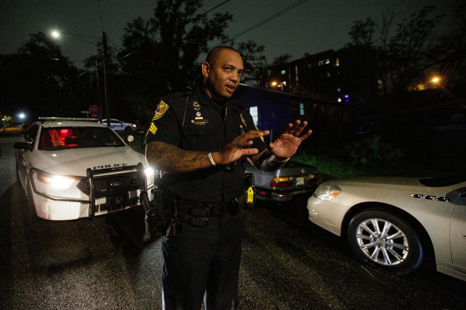 Tallahassee Police Department Sgt. Damon Miller stands in the street while talking with officers on his team while at the scene of a break-in on Wednesday, March 16, 2022.