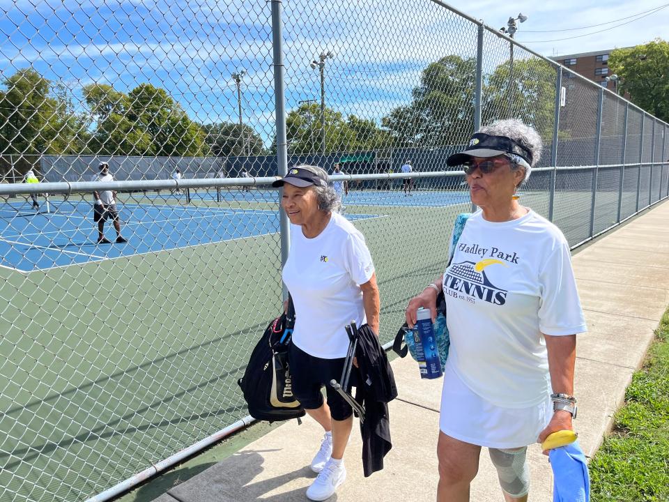 Ann Howse, 84, left, and Jo Ann Brannon, 79, right, are about to  walk onto the court to play in a Hadley Park Tennis Club event Saturday, Aug. 13, 2022.