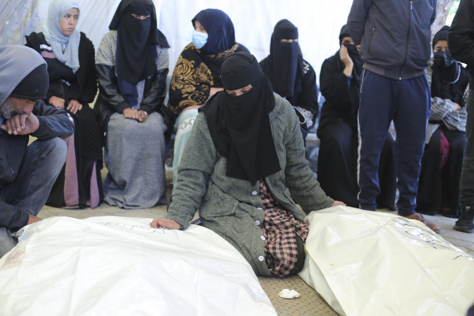A Palestinian woman mourns relatives killed in the Israeli bombardment of the Gaza Strip in a morgue of the European Gaza Hospital in Khan Younis, Tuesday, Jan. 16, 2024. (AP Photo/Hatem Ali)
