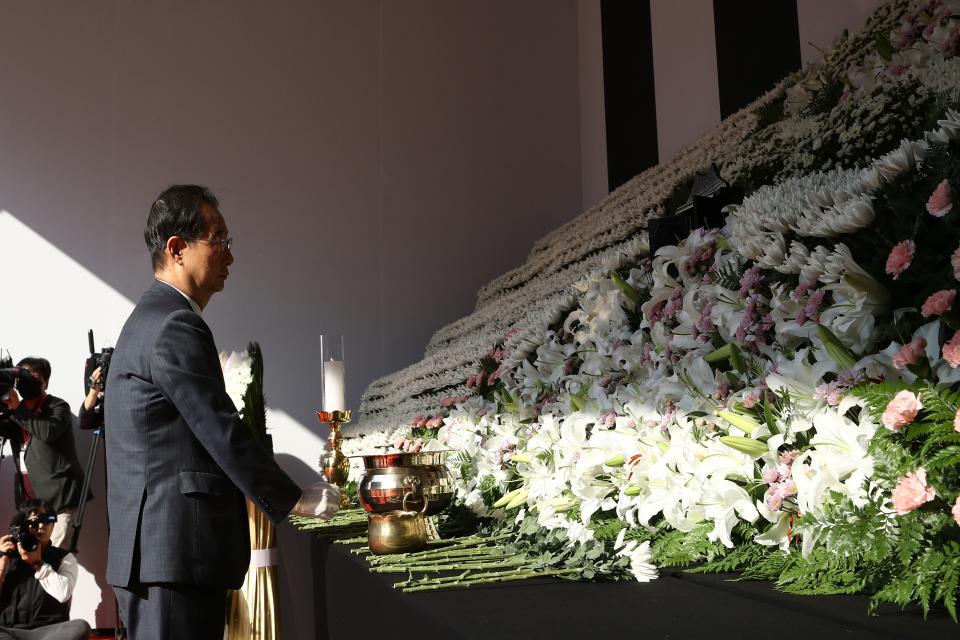 South Korea’s Prime Minister Han Duck-soo pays tribute at memorial altar for the victims of the Halloween celebration stampede,  in front of City Hall on 31 October 2022 in Seoul, South Korea (Getty Images)