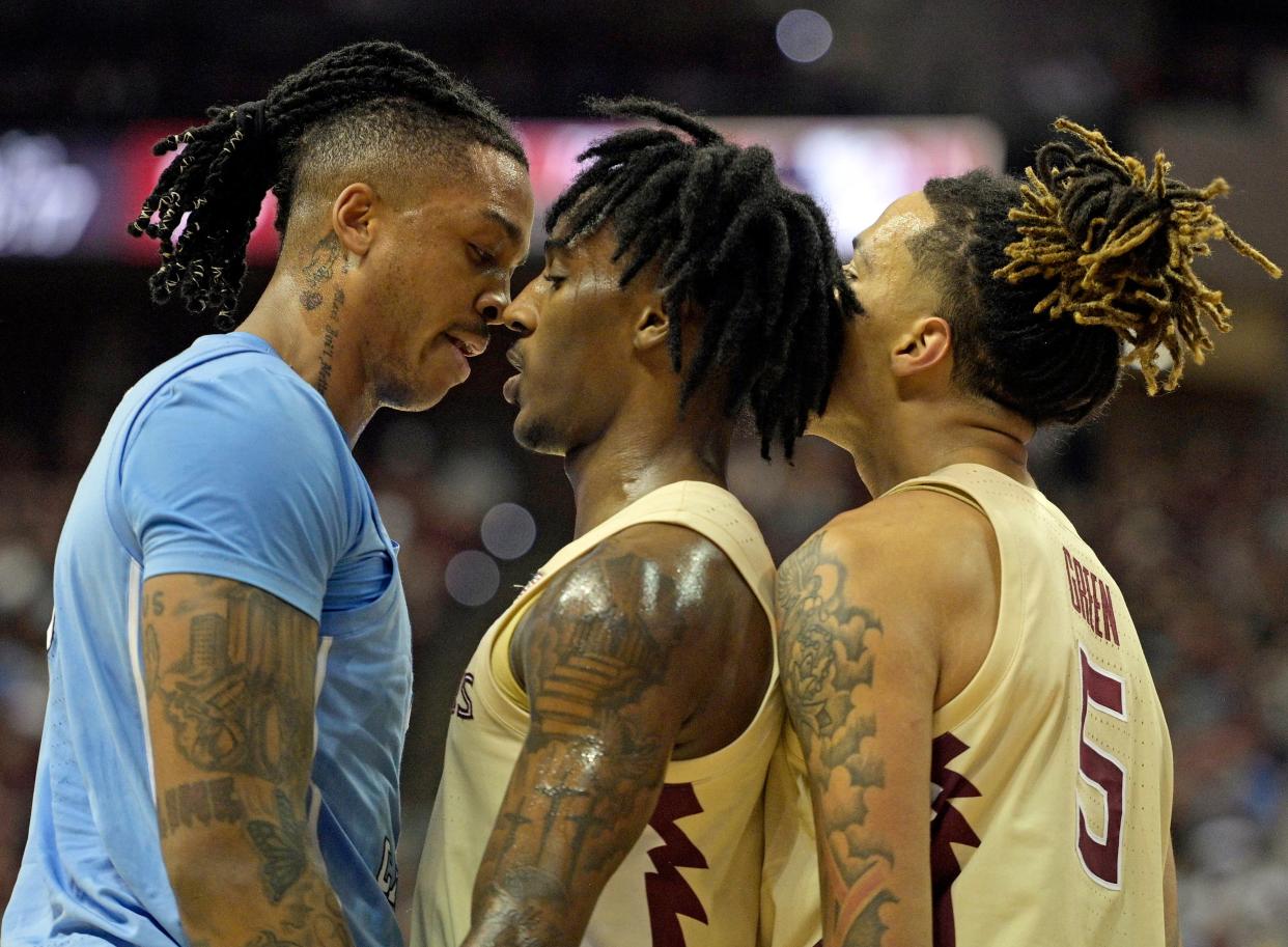 North Carolina Tar Heels center Armando Bacot (5) and Florida State Seminoles forward De'Ante Green (5) exchange words as forward Jamir Watkins (2) intervenes during the first half January 27, 2024, at Donald L. Tucker Center in Tallahassee, Florida.