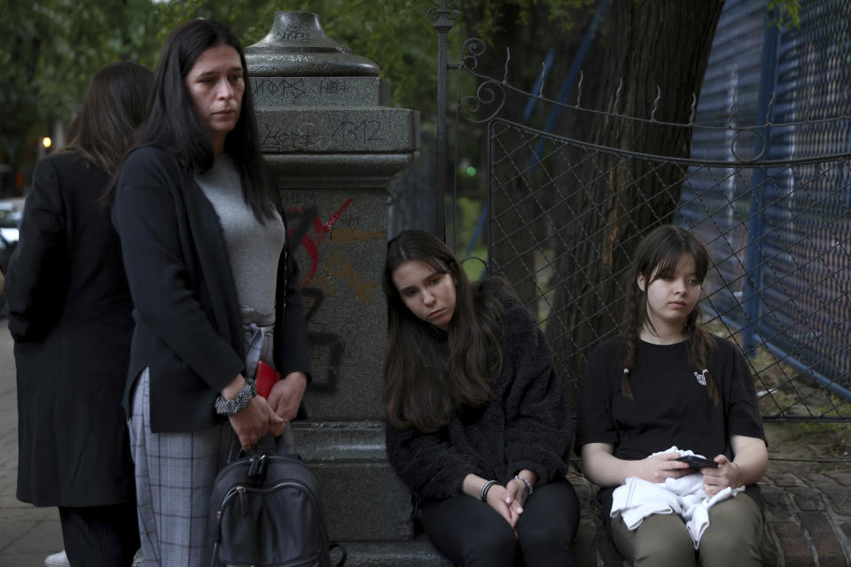 Women mourn near the Vladislav Ribnikar school in Belgrade, Serbia, Wednesday, May 3, 2023. A 13-year-old who opened fire Wednesday at his school in Serbia's capital drew sketches of classrooms and made a list of people he intended to target in a meticulously planned attack, police said. He killed eight fellow students and a guard before calling the police and being arrested. (AP Photo/Armin Durgut)