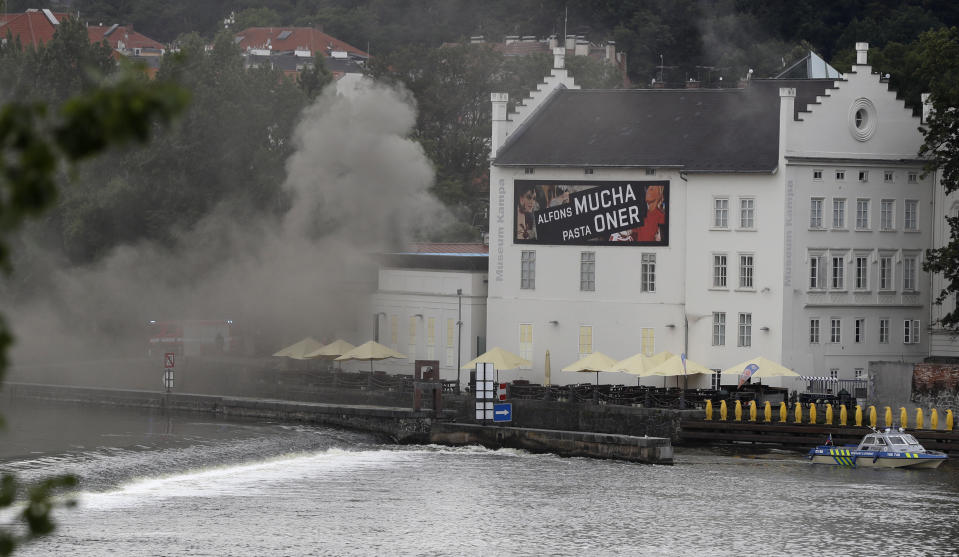 Smokes rises from a technical building of the Kampa Museum in Prague, Czech Republic, Wednesday, July 15, 2020. It was immediately not clear if any of the art pieces were damaged. Kampa Museum is known for its valuable collections of paintings by Frantisek Kupka, a pioneer of modern abstract painting. (AP Photo/Petr David Josek)