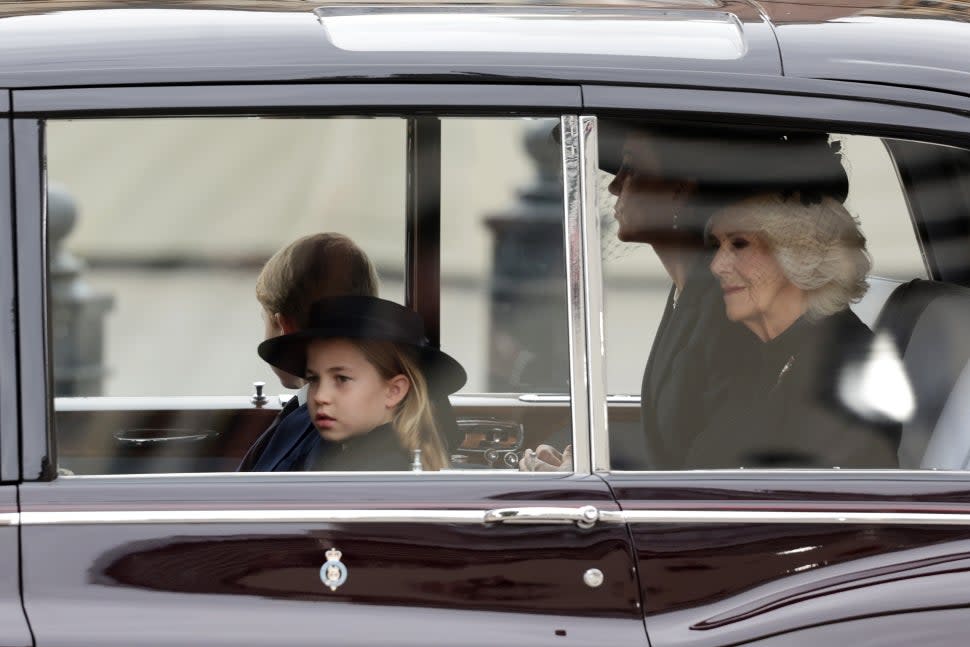 Princess Charlotte of Wales, Prince George of Wales, Camilla, Queen consort and Catherine, Princess of Wales are seen on The Mall ahead of The State Funeral for Queen Elizabeth II on September 19, 2022 in London, England