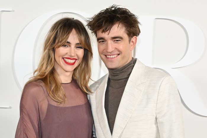 Suki and Robert smiling at a media event