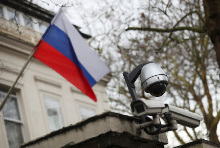 Security cameras are seen, and a flag flies outside the consular section of Russia's embassy in London, Britain, March 15, 2018. REUTERS/Hannah McKay