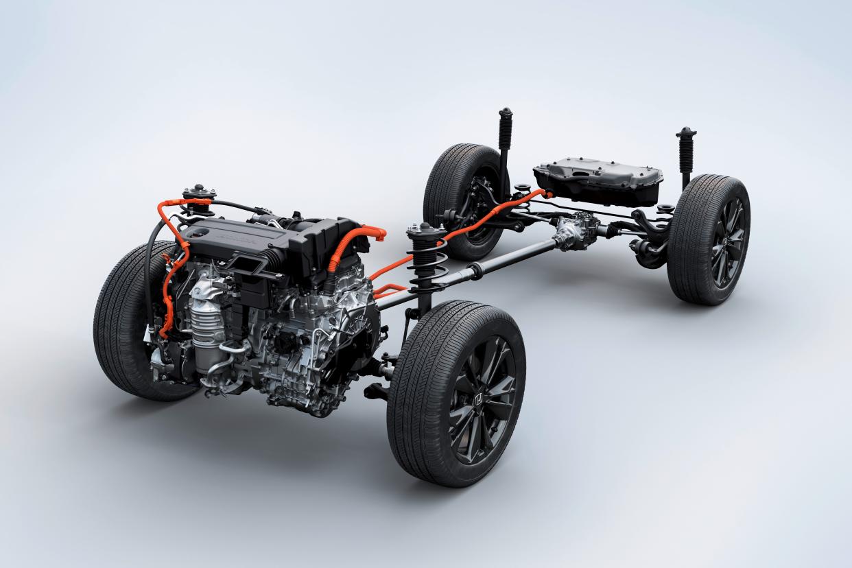 A photo showing the hybrid motors, battery, all-wheel-drive system, wheels, and suspension of a 2023-2025 Honda CR-V Hybrid SUV.