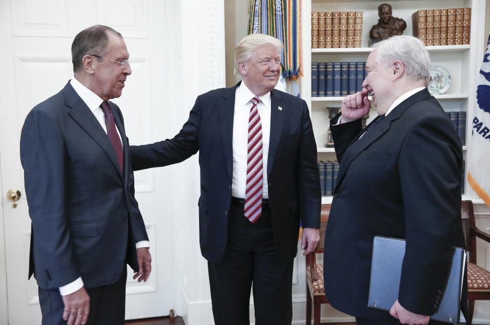 Russia's Foreign Minister Sergei Lavrov, President Donald Trump, and Russian Ambassador to the United States Sergei Kislyak talking during a meeting in the Oval Office.