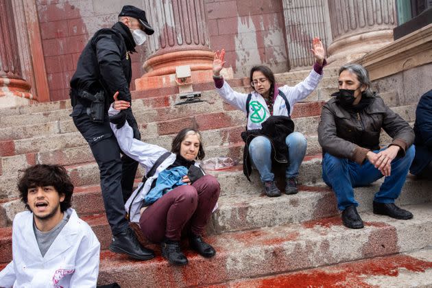 Police grab climate protesters from the steps of a government building in Madrid on April 6. (Photo: Aldara Zarraoa via Getty Images)