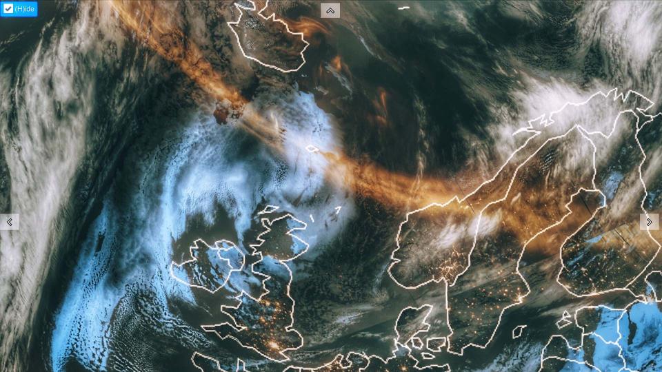 An orange-tinted band of aurora borealis spreads across the Atlantic Ocean in an image captured by the NOAA-2 weather forecasting satellite.