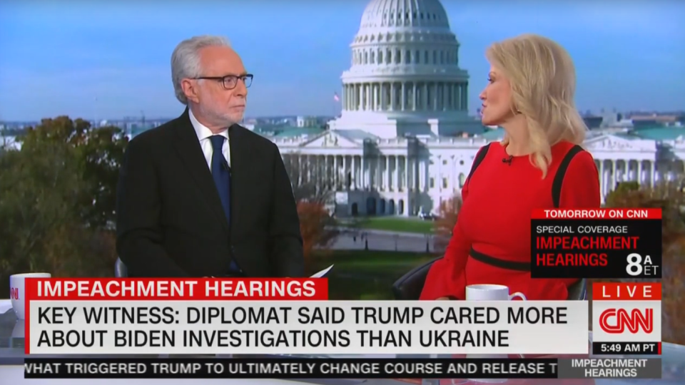 CNN's Wolf Blitzer listens to Kellyanne Conway during a live interview Thursday. (Screengrab via Yahoo News)