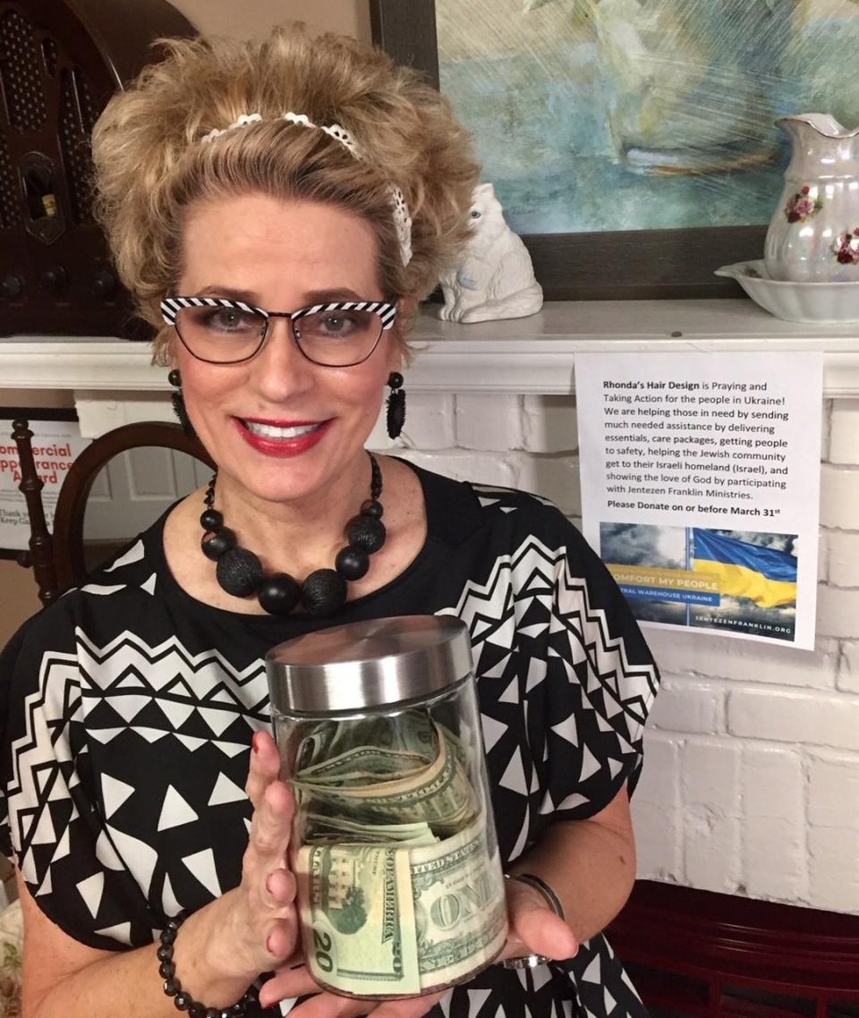 Customers of Rhonda's Hair Design gave $1,245 to help the people of Ukraine. Here, salon owner Rhonda Guffey, poses with her collection jar.