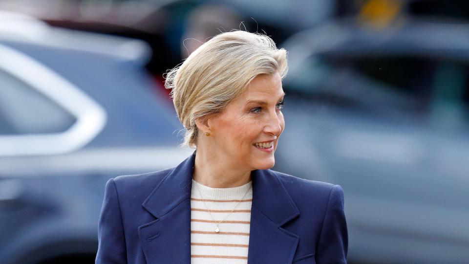 The Duchess of Edinburgh walking in striped top and navy suit