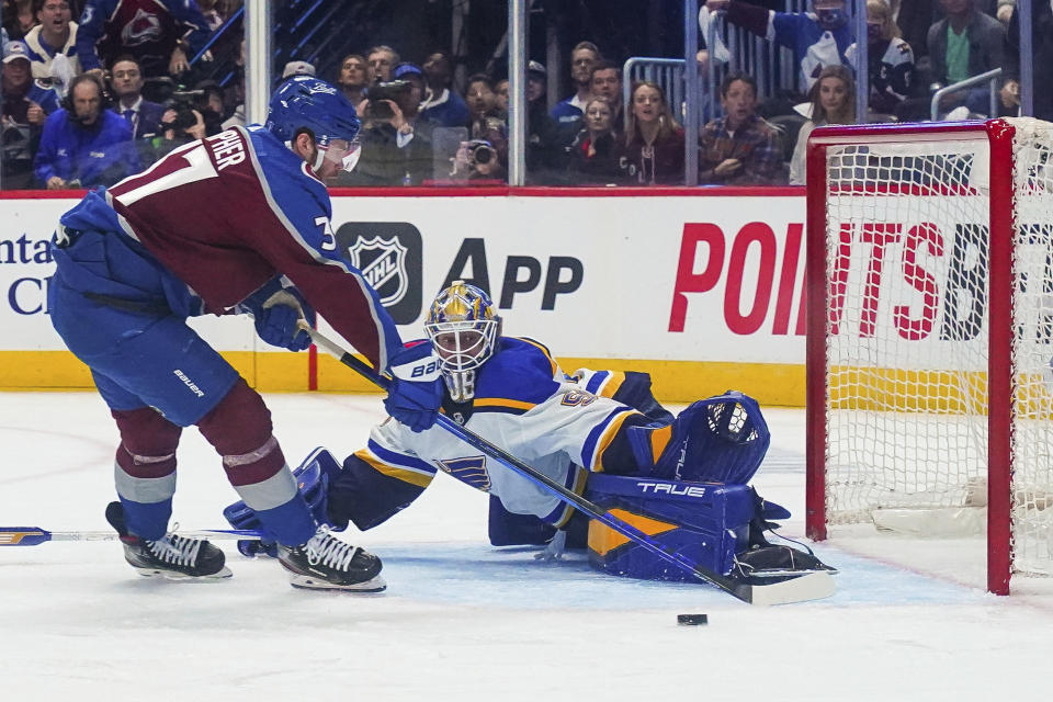 Colorado Avalanche left wing J.T. Compher (37) shoots against St. Louis Blues goaltender Jordan Binnington during the first period in Game 1 of an NHL hockey Stanley Cup second-round playoff series Tuesday, May 17, 2022, in Denver. (AP Photo/Jack Dempsey)