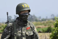 In this undated photo provided by South Korea Marine Corps' Facebook on Friday, May 8, 2020, Tottenham Hotspur forward Son Heung-min marches alone during a drill at a Marine Corps boot camp in Seogwipo on Jeju Island, South Korea. Son finished his three-week military training in South Korea on Friday and was right near the top of the class.(South Korea Marine Corps' Facebook via AP)