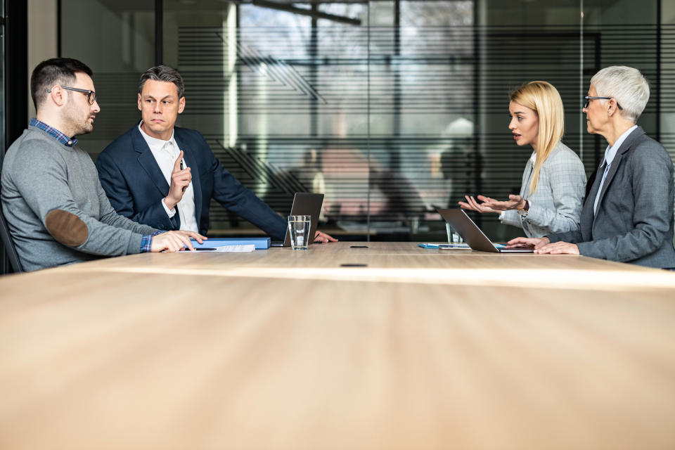 Married couple disputing with their lawyers present