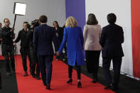 Centrist candidate and French President Emmanuel Macron and his wife Brigitte Macron arrive at a television recording studio for a debate with far-right leader Marine Le Pen, Wednesday, April 20, 2022 in La Plaine-Saint-Denis, outside Paris. In the climax of France's presidential campaign, centrist President Emmanuel Macron and far-right contender Marine Le Pen meet in a one-on-one television debate that could prove decisive before Sunday's runoff vote. (AP Photo/Francois Mori)