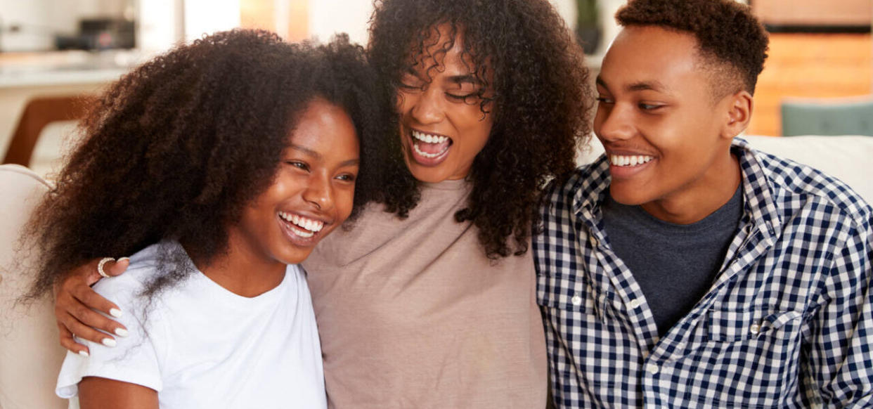 Black teen and young adult brother and sisters relaxing together, close up