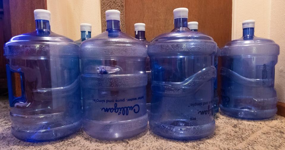 A week's worth of empty five-gallon water bottles sit by the door Feb. 10, 2021, at Tim Hartley's home on French Island near the airport in La Crosse. The home has one of least 40 wells in the area that were found to be contaminated with PFAS that are above recommended standards.