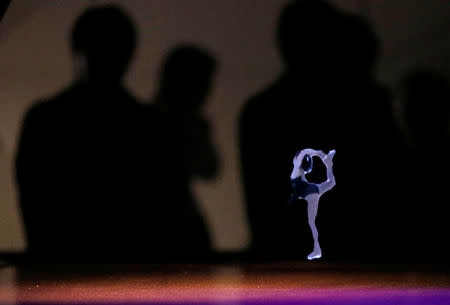 Japanese telecommunications company NTT's "Kirari! for Arena", which uses multiple cameras to track the movements of the player and images are transported to devices which show 3D hologram figures in real-time at a different location, shows a figure skater during the company's exhibition in Tokyo, Japan, February 22, 2018. REUTERS/Toru Hanai