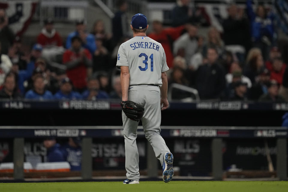 Los Angeles Dodgers starting pitcher Max Scherzer walks off the field after being relieved in the fifth inning in Game 2 of baseball's National League Championship Series against the Atlanta Braves Sunday, Oct. 17, 2021, in Atlanta. (AP Photo/Ashley Landis)