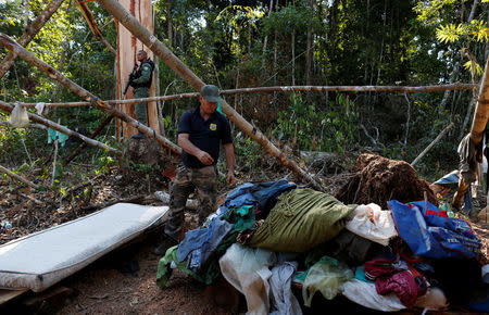 Agents of the Brazilian Institute for the Environment and Renewable Natural Resources, or Ibama, check an illegal logging camp during "Operation Green Wave" to combat illegal logging in Apui, in the southern region of the state of Amazonas, Brazil, August 3, 2017. REUTERS/Bruno Kelly