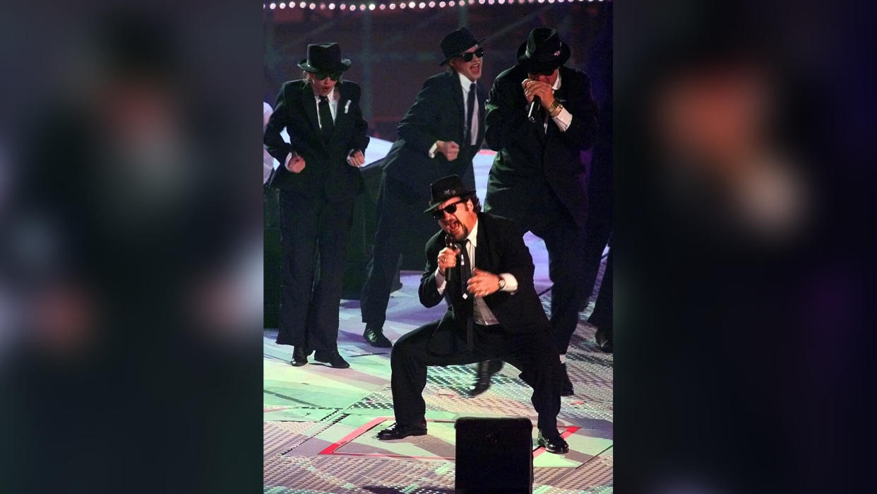 Jim Belushi performs as one of the Blues Brothers during halftime of Super Bowl XXXI, in New Orleans.