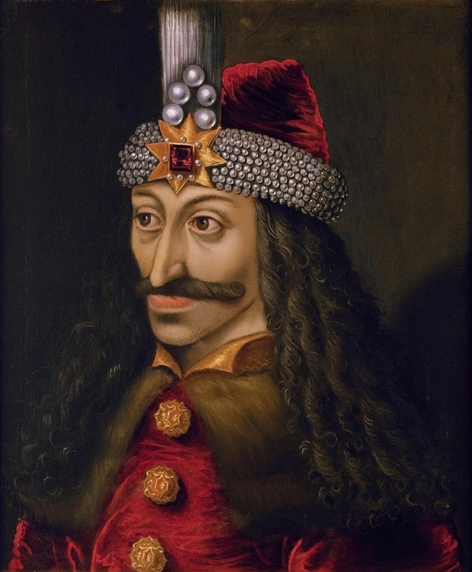 A portrait of Vlad the Impaler, wearing a headpiece with a star and five round jewels on the front, and a furry coat with big round buttons, and sporting long hair and a wide mustache.