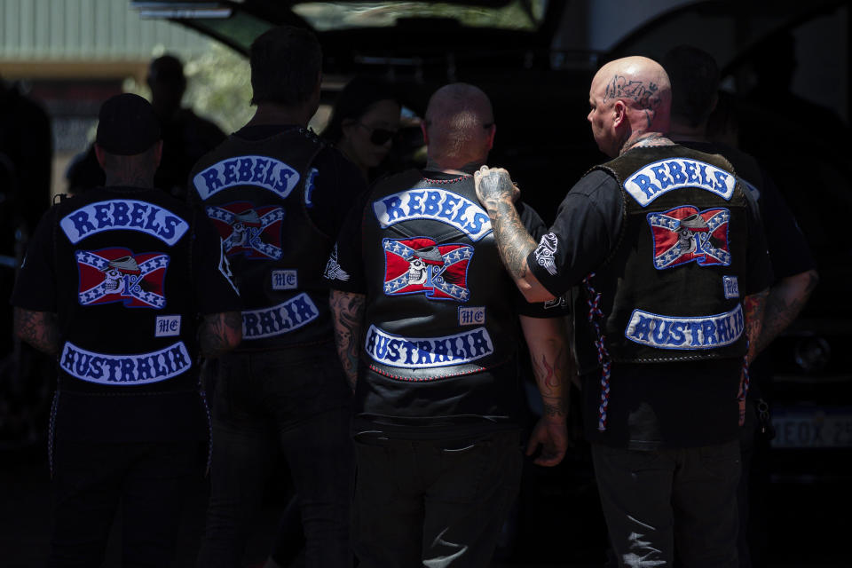 Mourners gather at a funeral parlor in north Perth, Australia before riding to the funeral of murdered Rebels biker Nick Martin at Pinnaroo Cemetery in Perth, Australia, on Wednesday, Dec. 23, 2020. The former Rebels president was gunned down earlier in the month at the Perth Motorplex. Martin’s murder left police a trove of evidence that led them to the culprit. But they wanted more. The coronavirus pandemic provided it in the form of an electronic dragnet: QR code check-in data from contact tracing apps of 2,439 fans who attended the December 2020 race. (Richard Wainwright/AAP via AP)