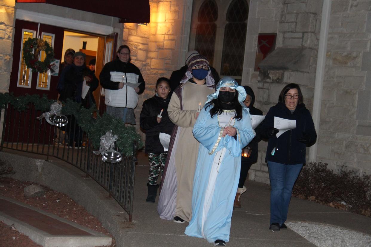 Siblings Steven and Stephanie Mena, dressed as Joseph and Mary, lead the Las Posadas procession on Thursday, Dec. 16, 2021.