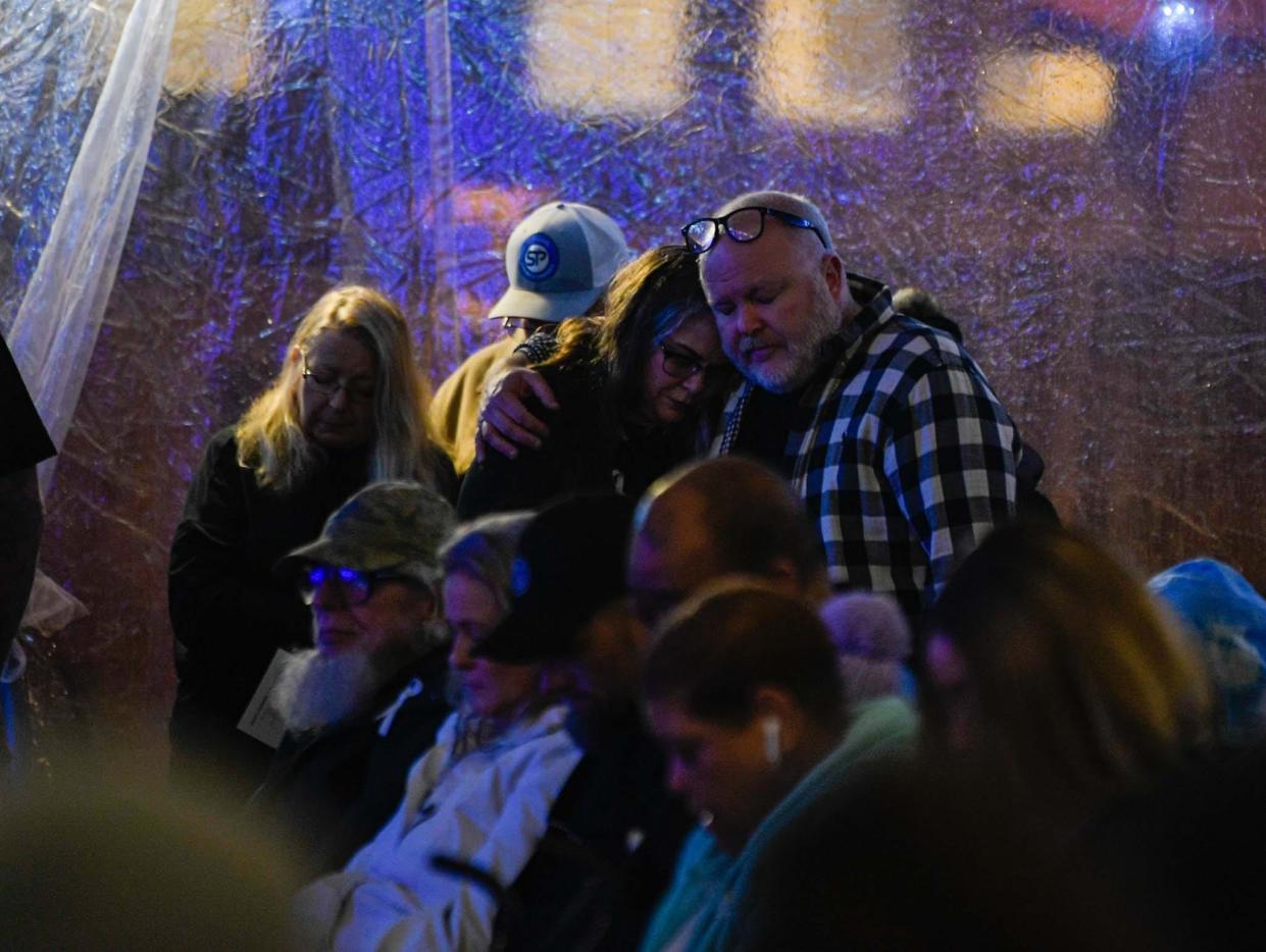 Families pray over the victims of homicide, at the 28th annual Season to Remember Memorial Service at Centennial Art Center in Nashville, Tenn., Thursday, Dec. 8, 2022. 