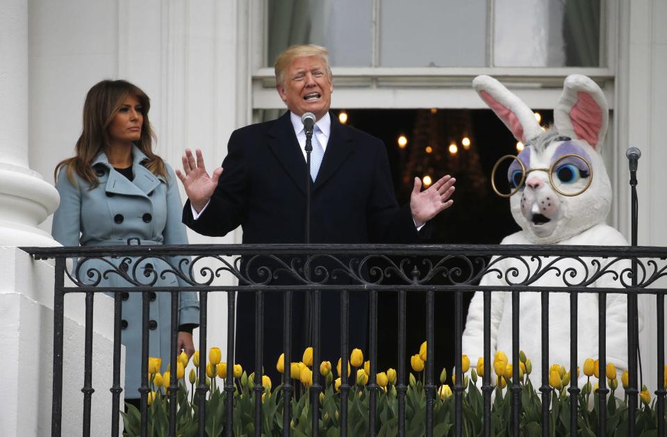 Trump speaks with first lady Melania Trump and the Easter Bunny at his sides at the annual White House Easter Egg Roll on Monday. (Leah Millis/Reuters)